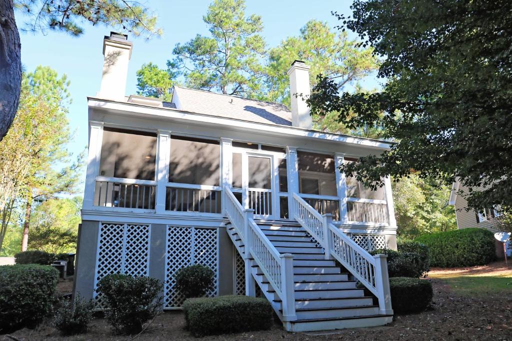 Enjoy our outdoor Tv and screened porch at Marina Cottage - image 3