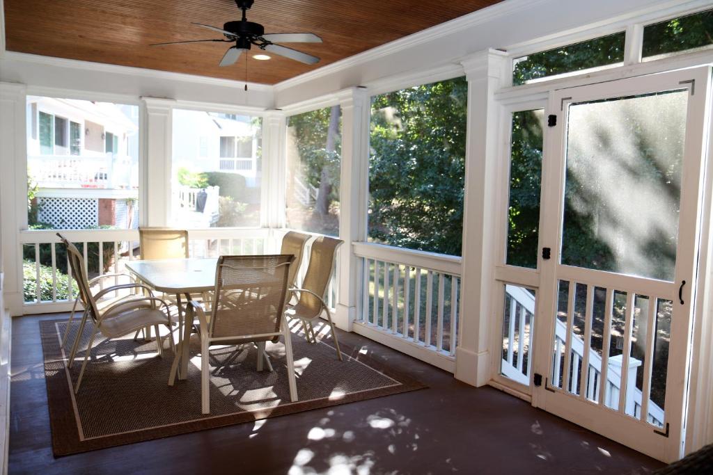 Enjoy our outdoor Tv and screened porch at Marina Cottage - image 6