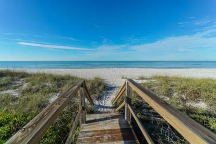 Villa By the Sea is only steps to the white sand beach gear and 6 bikes for your use Florida