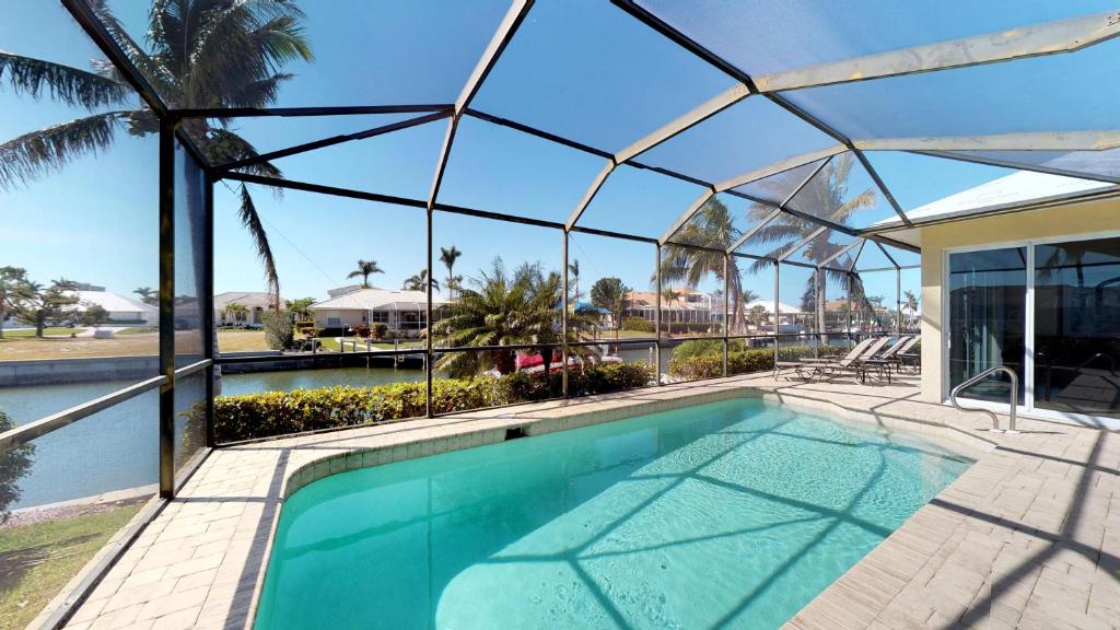 Waterfront 3 Bed Plus Den 3 Bath HomeHeated Pool w/ Large Screened-In Lanai! - main image